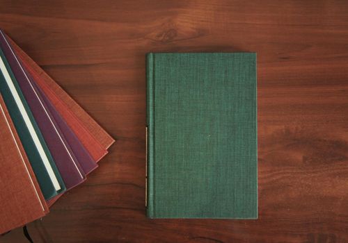Books and notebook on a wooden table